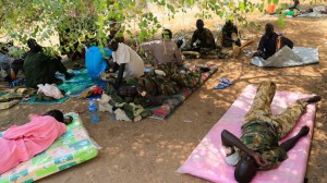 Wounded South Sudan military personnel receive medical treatment under a tree at the general military hospital compound in the capital Juba December 28, 2013. (Reuters/James Akena)