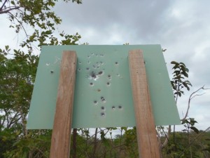 The bullet-ridden entrance sign to the Pycobcatejê Reserve “Governador” 